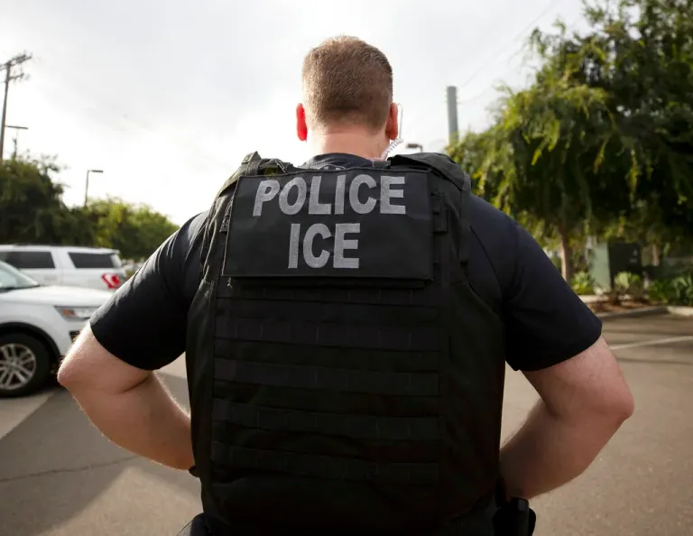 The vest of an agent says Police ICE