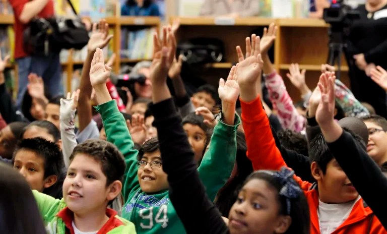 IMAGE DISTRIBUTED FOR SKYPE - In this image released on Monday, April 1, 2013, students wave hello to explorer Mark Wood at McWhorter Elementary in Dallas. Wood is connecting with the students via Skype video call from Mt. Everest as part of the Skype in the classroom program. (Brandon Wade/AP Images for Skype)