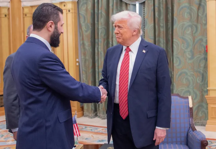In this photo released by the Saudi Royal Palace, President Donald Trump, right, shakes hands with Syria's interim President Ahmad al-Sharaa, in Riyadh, Saudi Arabia, Wednesday, May 14, 2025.
