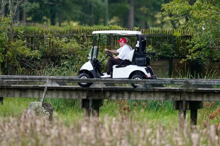 President Donald Trump rides around his golf course at Trump National Golf Club in Sterling, Virginia, Monday, Sept. 12, 2022.