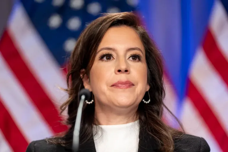 Rep. Elise Stefanik, R-N.Y., is seated before President-elect Donald Trump.
