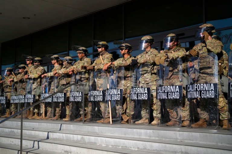 California National Guard members stand in formation guarding the federal building in downtown Los Angeles on Tuesday, June 10, 2025.