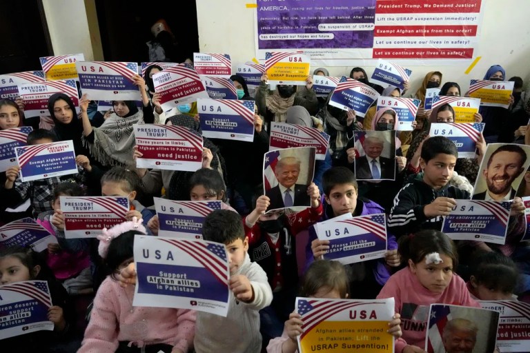 FILE - Afghan refugees hold placards during their meeting to discuss situation after President Donald Trump paused the U.S. refugee programs, in Islamabad, Pakistan, Friday, Jan. 24, 2025.