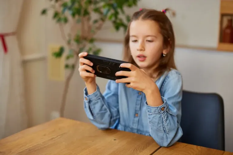 A child playing a mobile game on a smartphone.