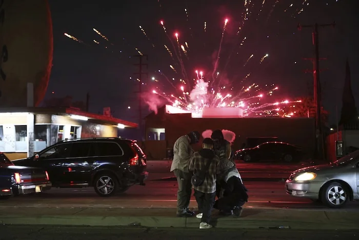 Protesters attempt to light a Molotov cocktail as a firework explodes during a protest in Compton, Calif., Saturday, June 7, 2025, after federal immigration authorities conducted operations. (AP Photo/Ethan Swope)