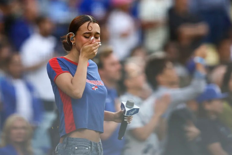 Music artist Nezza reacts after singing the national anthem prior to a baseball game between the Los Angeles Dodgers and the San Francisco Giants in Los Angeles, Saturday, June 14, 2025. (AP Photo/Jessie Alcheh)