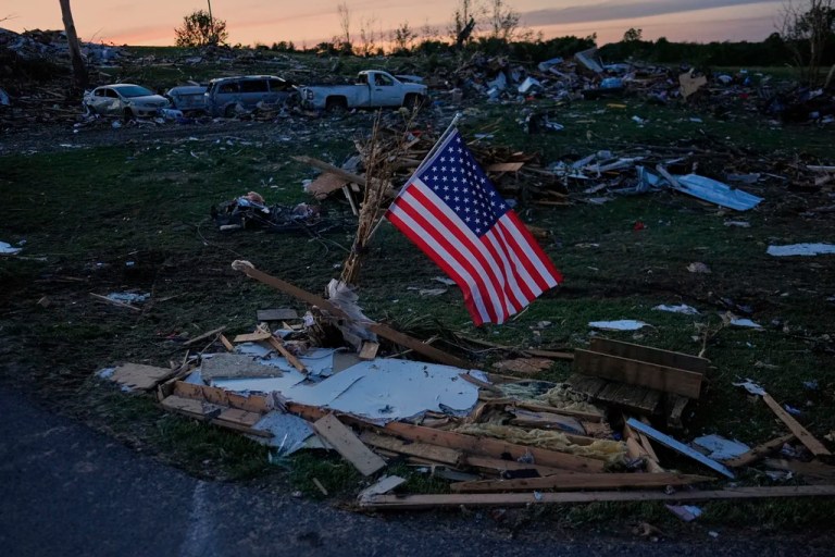 An American flag is posted near destroyed homes after a tornado passed through the area on May 17, 2025, in London, Ky.