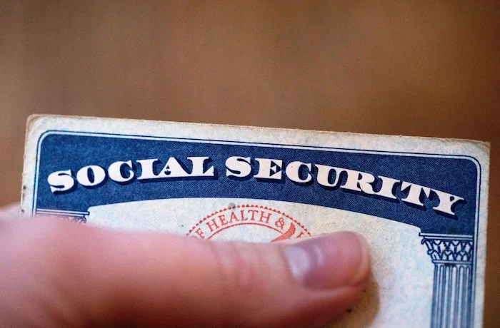 FILE - A Social Security card is displayed on Oct. 12, 2021, in Tigard, Ore. The go-broke dates for Medicare and Social Security’s trust funds have moved up as rising health care costs and new legislation affecting Social Security benefits have contributed to closer projected depletion dates.