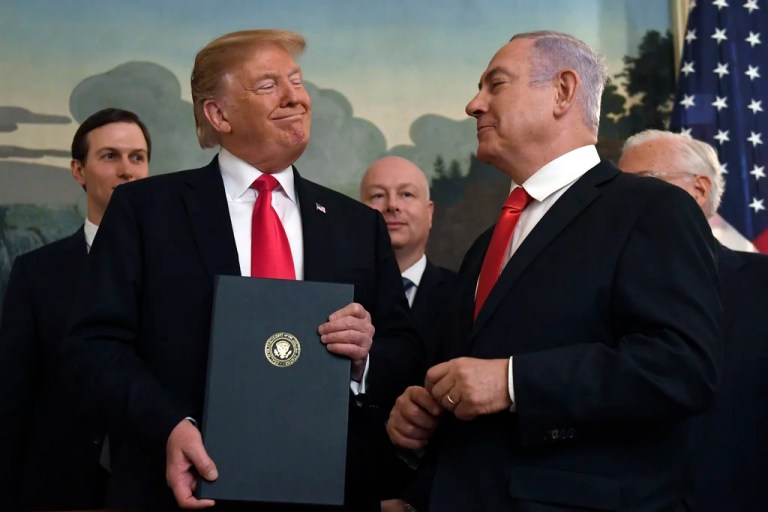 In this March 25, 2019 file photo, President Donald Trump smiles at Israeli Prime Minister Benjamin Netanyahu, right, after signing a proclamation at the White House in Washington.