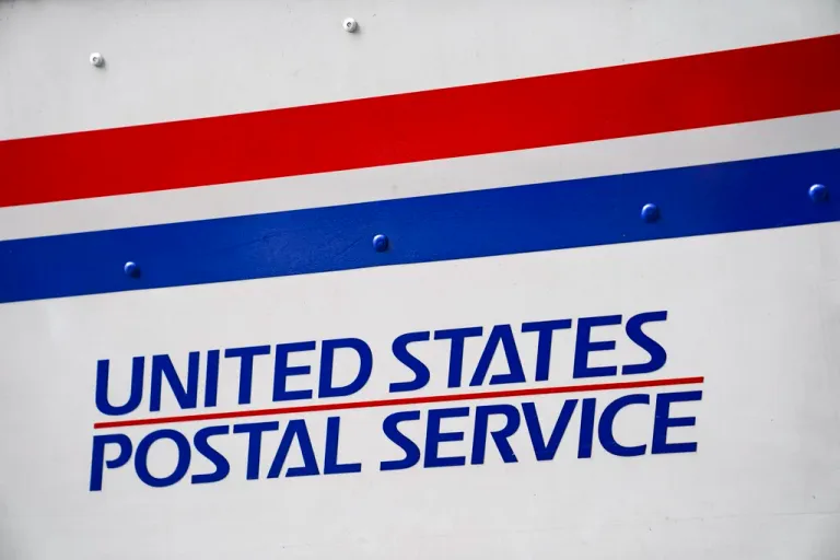 A U.S. Postal Service delivery truck is parked beside the Canal Street station, Monday, Aug. 17, 2020, in New York. (AP Photo/John Minchillo)