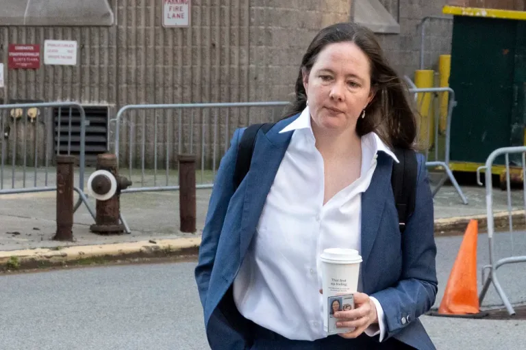 Assistant U.S. Attorney Maurene Comey walks outside.