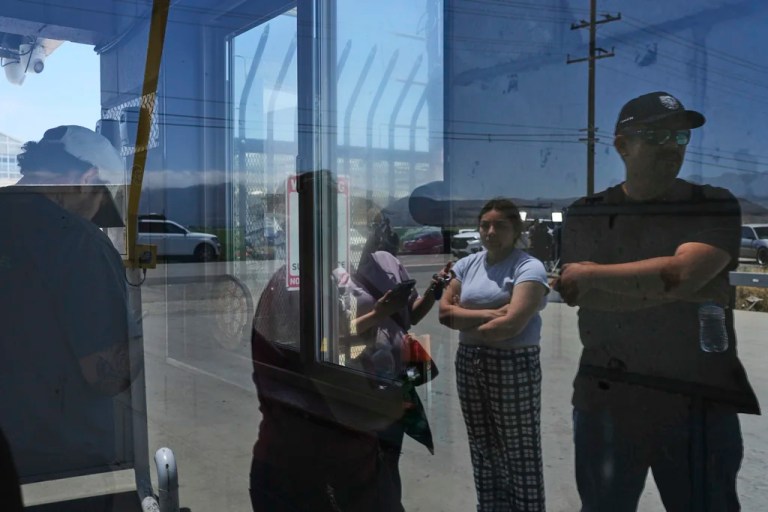 People wait outside of Glass House Farms, a day after an immigration raid on the facility, Friday, July 11, 2025, in Camarillo, Calif.
