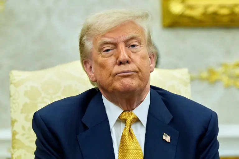 Trump in blue suit, yellow tie serious