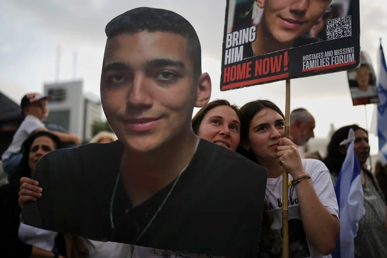 FILE - People watch a live broadcast of Israeli-American soldier Edan Alexander as he is released from Hamas captivity in Gaza, at a plaza known as the hostages square in Tel Aviv, Monday, May 12, 2025. (AP Photo/Oded Balilty, File)