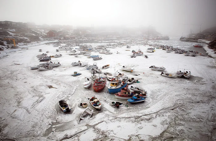 Boats frozen in the harbor in Ilulissat, Greenland, May 2025.