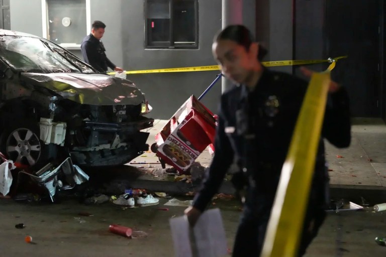 Law enforcement investigate the scene where a vehicle rammed into a crowd of people waiting to enter a nightclub along a busy boulevard in Los Angeles early Saturday, July 19, 2025 injuring several people.