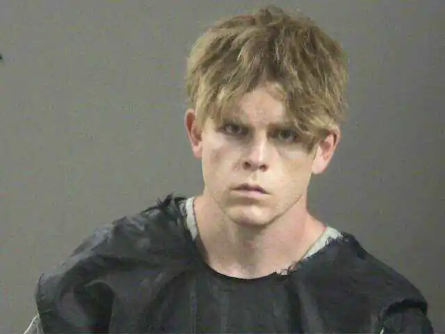 Arkansas teacher charged in stabbing deaths of father and mother hiking with their children