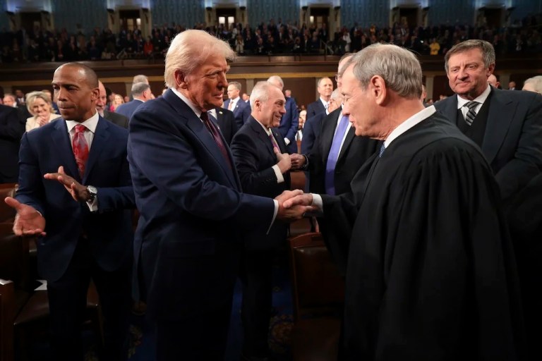 FILE - President Donald Trump, center, greets Chief Justice of the Supreme Court John Roberts, right, as he arrives to address a joint session of Congress at the Capitol in Washington, March 4, 2025. (Win McNamee/Pool Photo via AP, File)