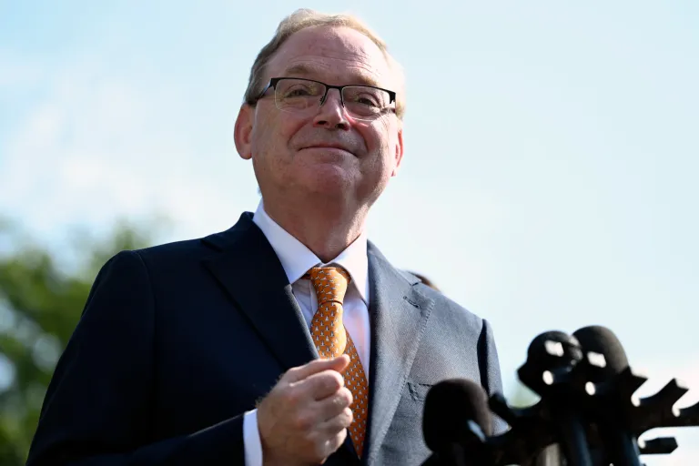 Kevin Hassett stands in front of a microphone
