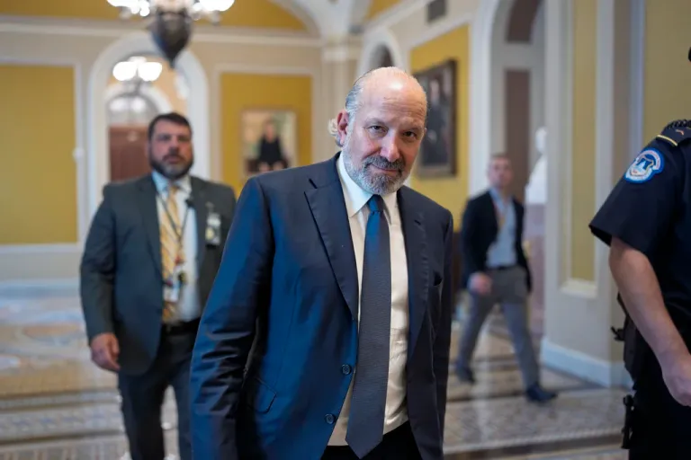 Commerce Secretary Howard Lutnick walks through a corridor at the Senate.