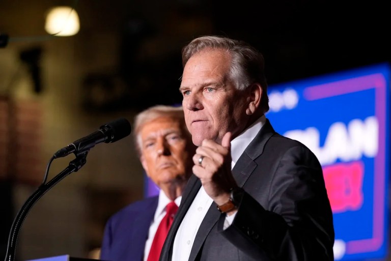 Then-Republican presidential nominee former President Donald Trump listens as Senate candidate former Rep. Mike Rogers, speaks at a campaign event at the Ryder Center at Saginaw Valley State University, Thursday, Oct. 3, 2024, in University Center, Mich.