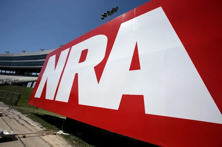 FILE - An NRA sign is seen outside the track of the NASCAR Sprint Cup series, April 12, 2013, in Fort Worth, Texas. (AP Photo/Tim Sharp, File)