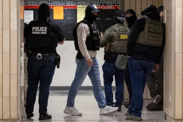 Federal agents walk around at immigration court.
