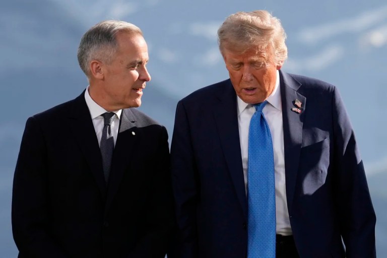 Canadian Prime Minister Mark Carney talks with President Donald Trump before a group photo at the G7 Summit, Monday, June 16, 2025, in Kananaskis, Canada.