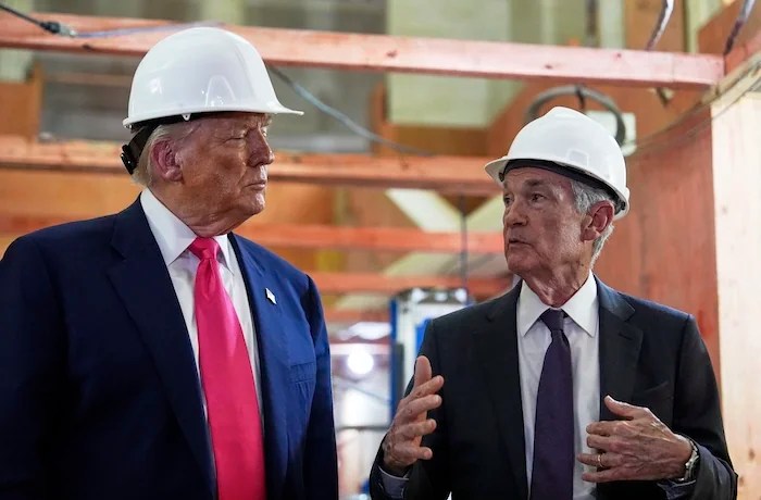 President Donald Trump listens as Federal Reserve Chairman Jerome Powell speaks during a visit to the Federal Reserve, Thursday, July 24, 2025, in Washington.