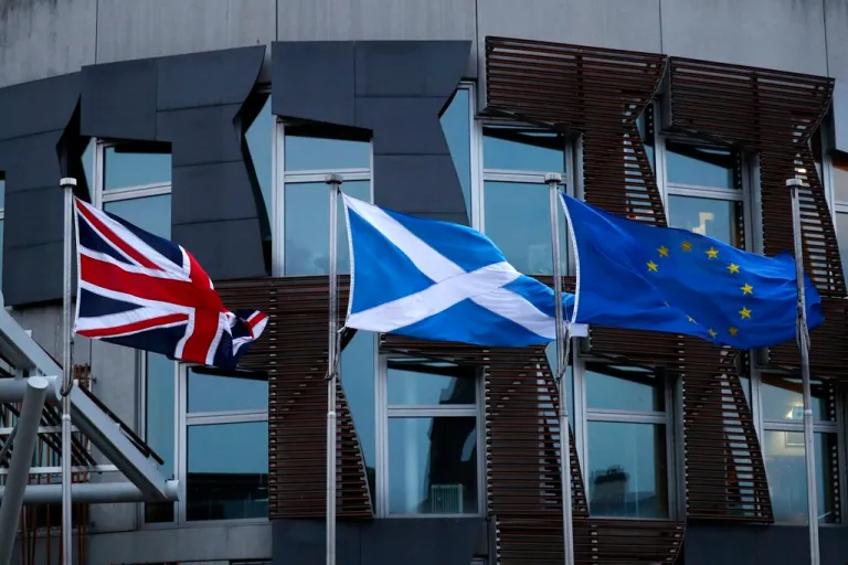 The flags of Britain, Scotland and European Union wave outside the Scottish parliament in Edinburgh, Friday, Jan. 31, 2020. Britain officially leaves the European Union on Friday after a debilitating political period that has bitterly divided the nation since the 2016 Brexit referendum.