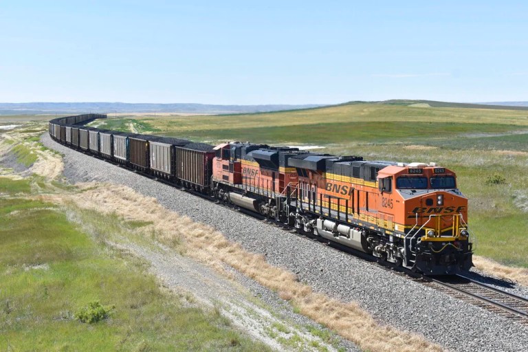 A BNSF railroad train hauling carloads of coal from the Powder River Basin of Montana and Wyoming is seen east of Hardin, Mont., on July 15, 2020. The major freight railroads are hiring aggressively and asking customers to cut the number of carloads they are shipping to reduce congestion along the rail network in response to concerns from agricultural and ethanol groups that prompted regulators to schedule a hearing on the problems.
