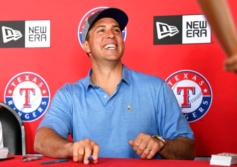 Mark Teixeira smiles in front of a MLB Texas Rangers backdrop