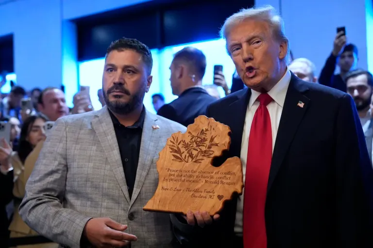 Republican presidential nominee former President Donald Trump talks with owner Albert Abbas as he visits The Great Commoner, Friday, Nov. 1, 2024, in Dearborn, Michigan.