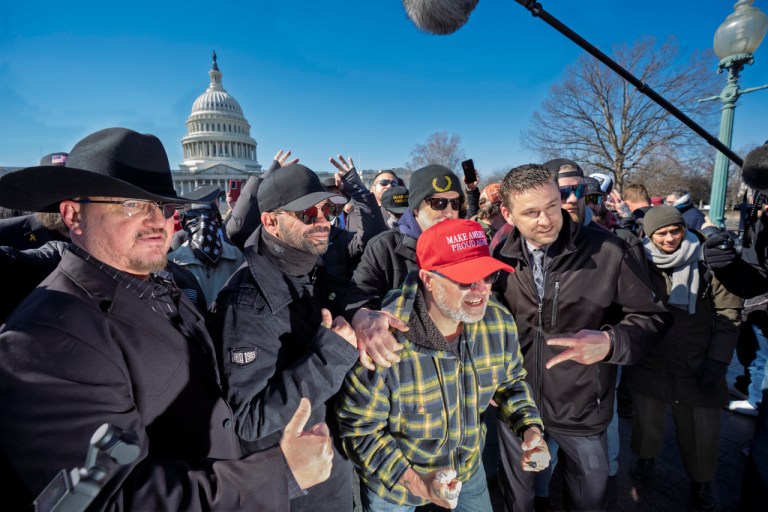 Oath Keepers founder Stewart Rhodes, from left, former Proud Boys leader Enrique Tarrio, Joseph Biggs, and Zachary Rehl pose at a news conference at the U.S. Capitol in Washington, Feb. 21, 2025.