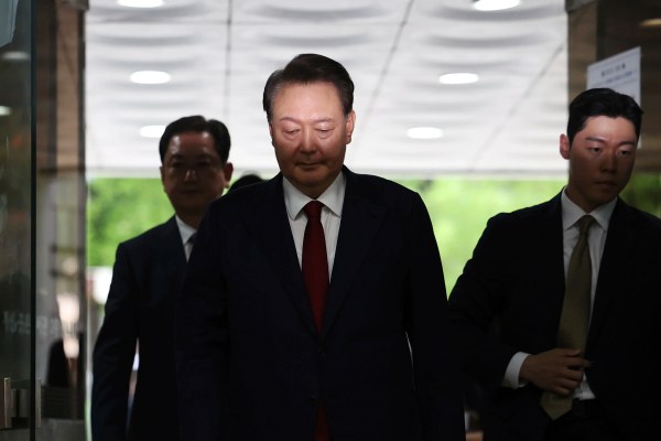 Ousted South Korea president protests interrogation by laying flat in his underwear, refusing to move