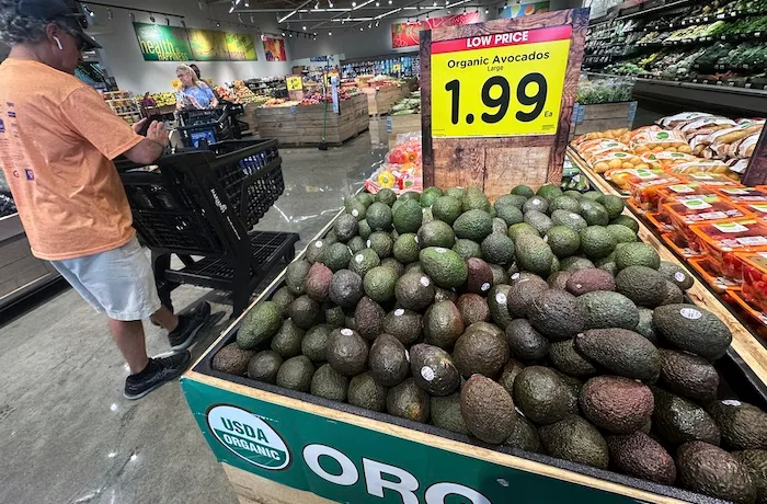 Avocados are displayed as customers shop at a grocery store in Glenview, Ill., Tuesday, July 15, 2025.