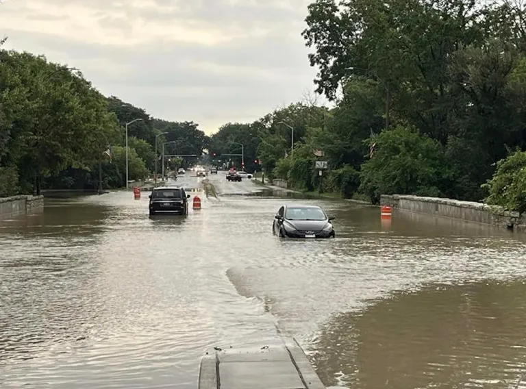 This image provided by CBS58 shows cars on a flooded street in Milwaukee, Sunday, Aug. 10, 2025.