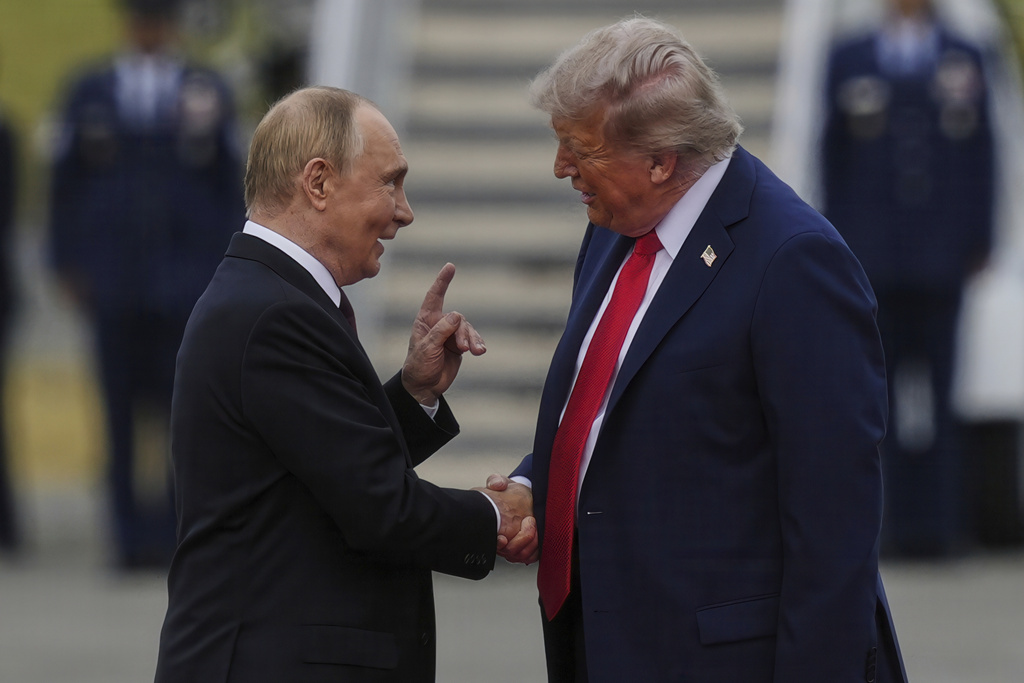 President Donald Trump greets Russia's President Vladimir Putin on Friday, Aug. 15, 2025, at Joint Base Elmendorf-Richardson, Alaska. (AP Photo/Julia Demaree Nikhinson)