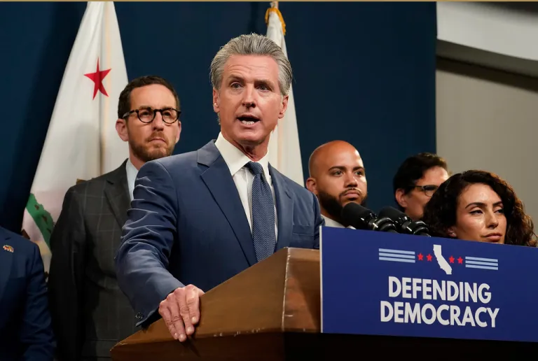 Gov. Gavin Newsom addresses reporters after signing a package of measures to redraw the state's Congressional districts and put new maps before voters in a special election, in Sacramento, Calif.,Thursday, Aug. 21, 2025. (AP Photo/Rich Pedroncelli)