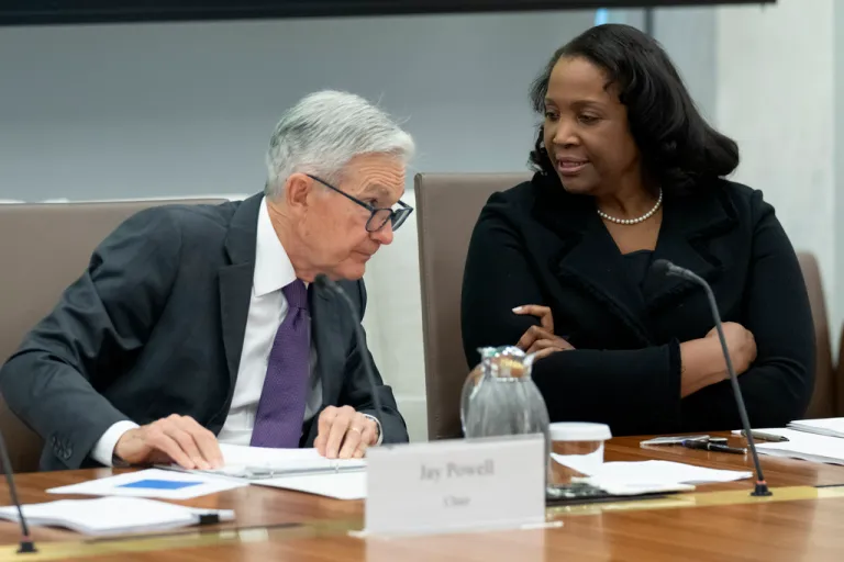 Federal Reserve Chairman Jerome Powell, left, talks with Board of Governors member Lisa Cook, right, during an open meeting of the Board of Governors at the Fed, June 25, 2025, in Washington.
