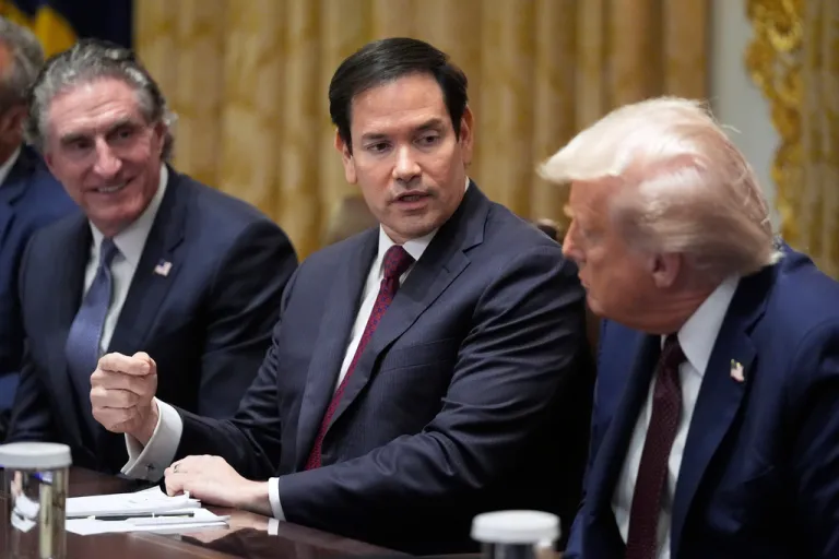 President Donald Trump, right, listens as Secretary of State Marco Rubio speaks during a Cabinet meeting in the White House.
