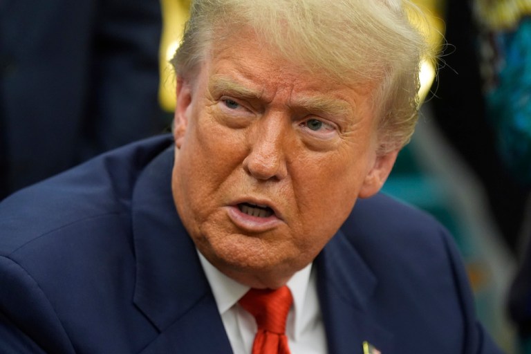 President Donald Trump answers questions from reporters.