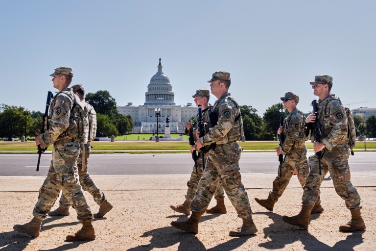 Armed National Guard soldiers from West Virginia patrol the Mall near the Capitol in Washington, as part of President Donald Trump's order to impose federal law enforcement in the nation's capital, Tuesday, Aug. 26, 2025.