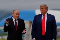 Putin taps ear and shrugs when asked whether he would stop ‘killing civilians’