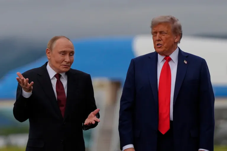 Putin taps ear and shrugs when asked whether he would stop ‘killing civilians’