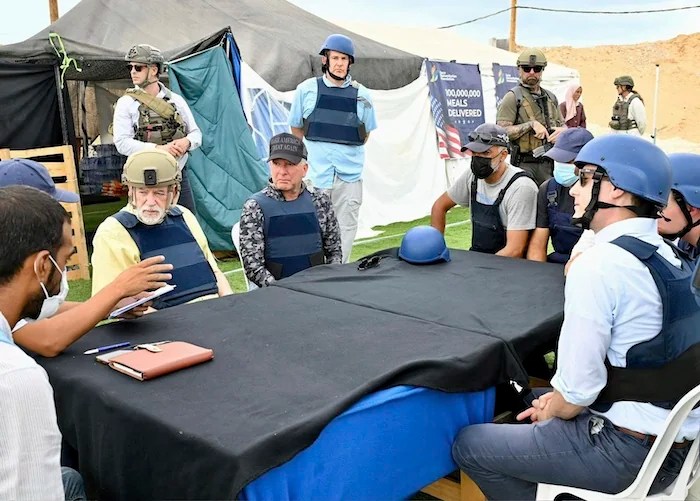 This handout photo from US Embassy Jerusalem shows White House special envoy Steve Witkoff, center, and US Ambassador to Israel Mike Huckabee, center left, visiting a food distribution site run by the Gaza Humanitarian Foundation, a U.S.-backed organization approved by Israel, in Gaza City, Friday, Aug. 1, 2025.