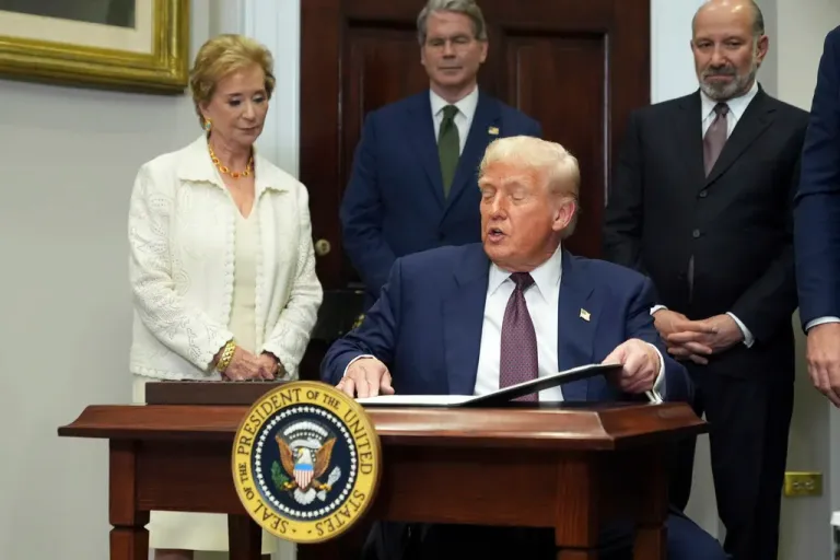 President Donald Trump signs an executive order.