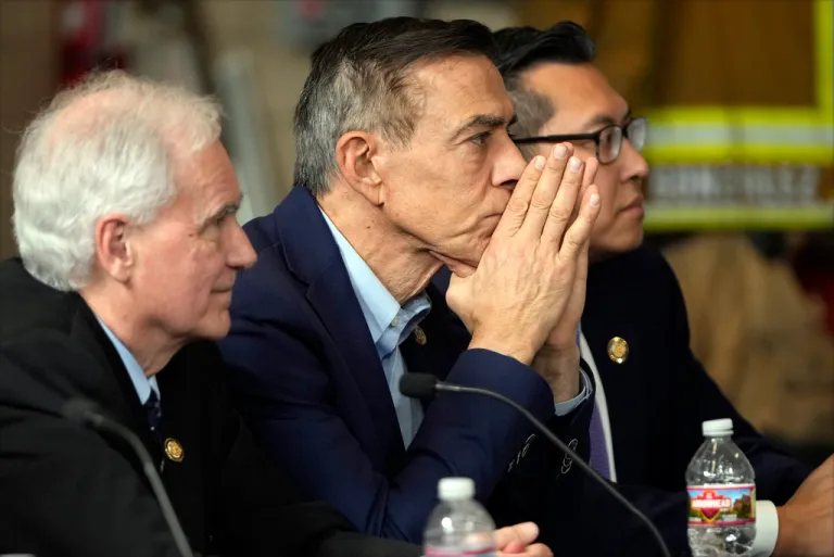 Re. Darrell Issa (R-CA), center, listens as President Donald Trump speaks during a briefing during a tour of the Pacific Palisades neighborhood affected by recent wildfires in Los Angeles, Friday, Jan. 24, 2025.