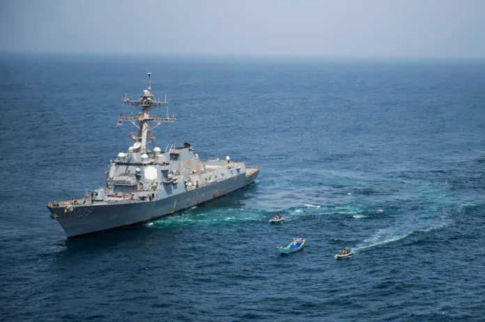 This photo made available Thursday, Aug. 28, 2018, shows a visit, board, search, and seizure team from the guided-missile destroyer USS Jason Dunham (DDG 109) approaching a skiff during a flag verification boarding as part of maritime security operations.