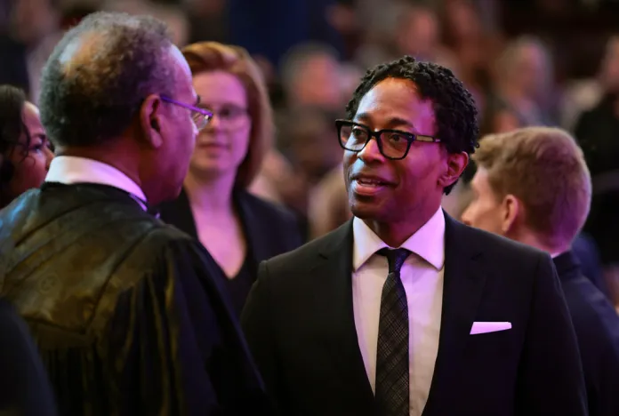 Rev. Emanuel Cleaver II, left, of Kansas City, talks with St. Louis County prosecutor Wesley Bell.